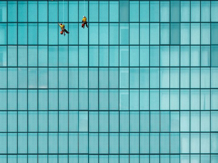 3 surveyors conducting reviews while rappelled from a building