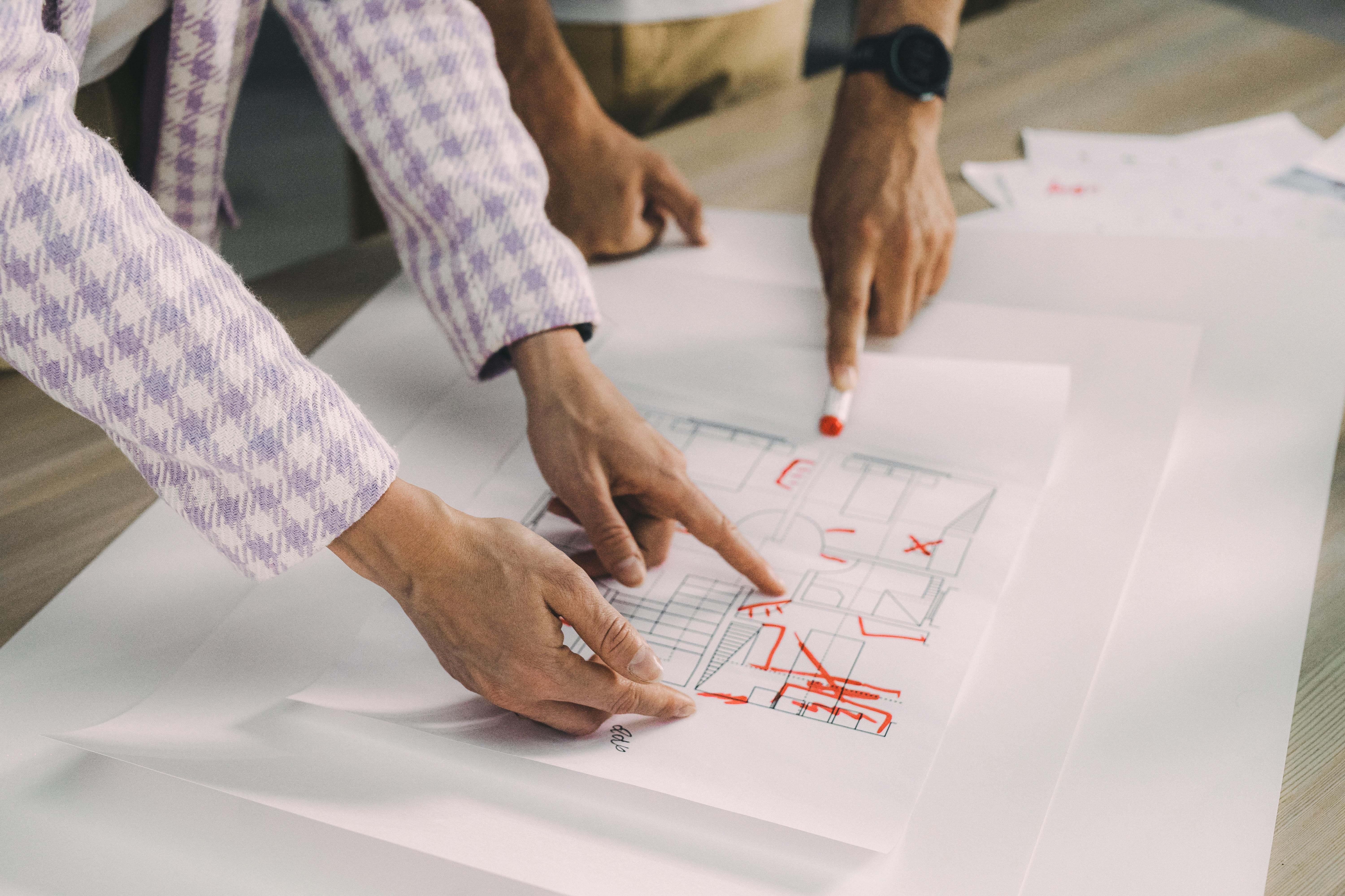 Individuals reviewing architectural drawings
