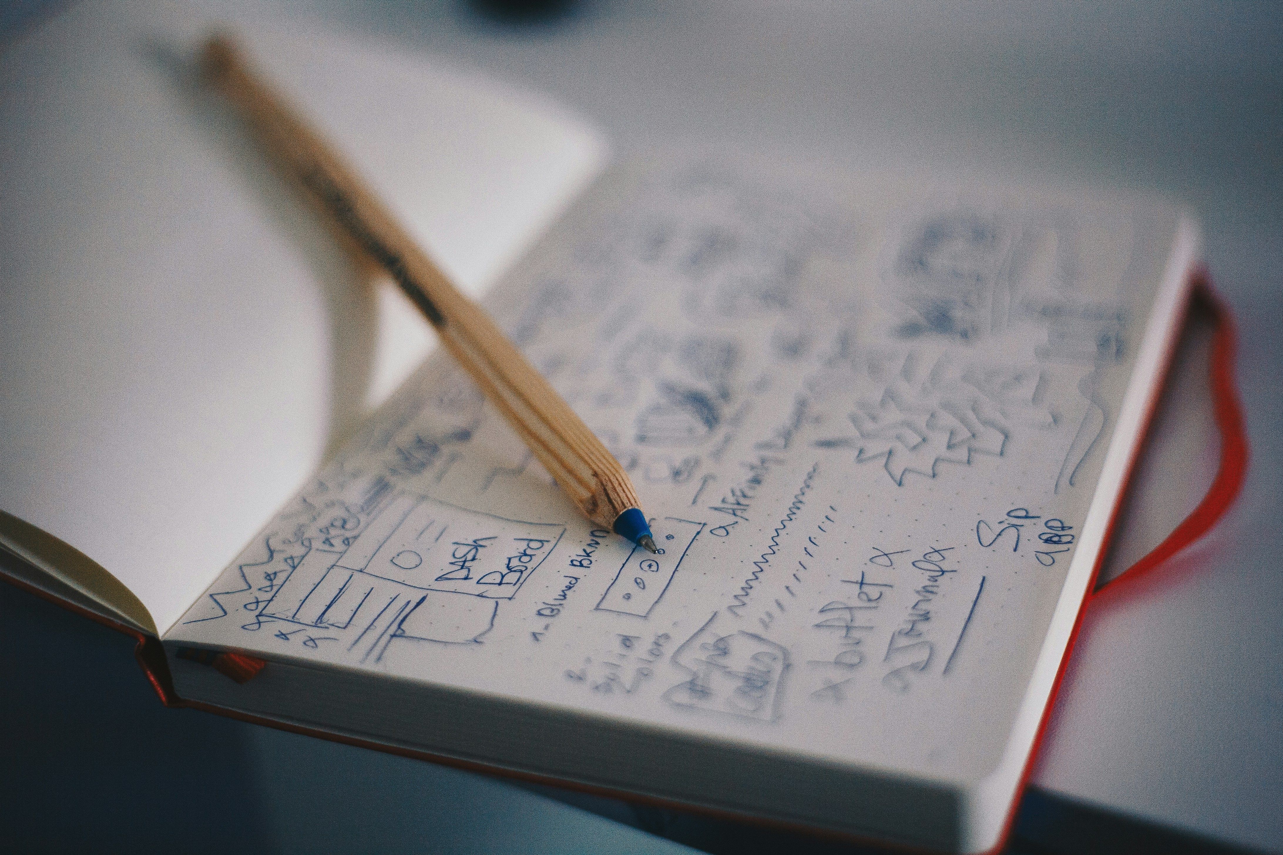 Rough designs jotted across a notebook