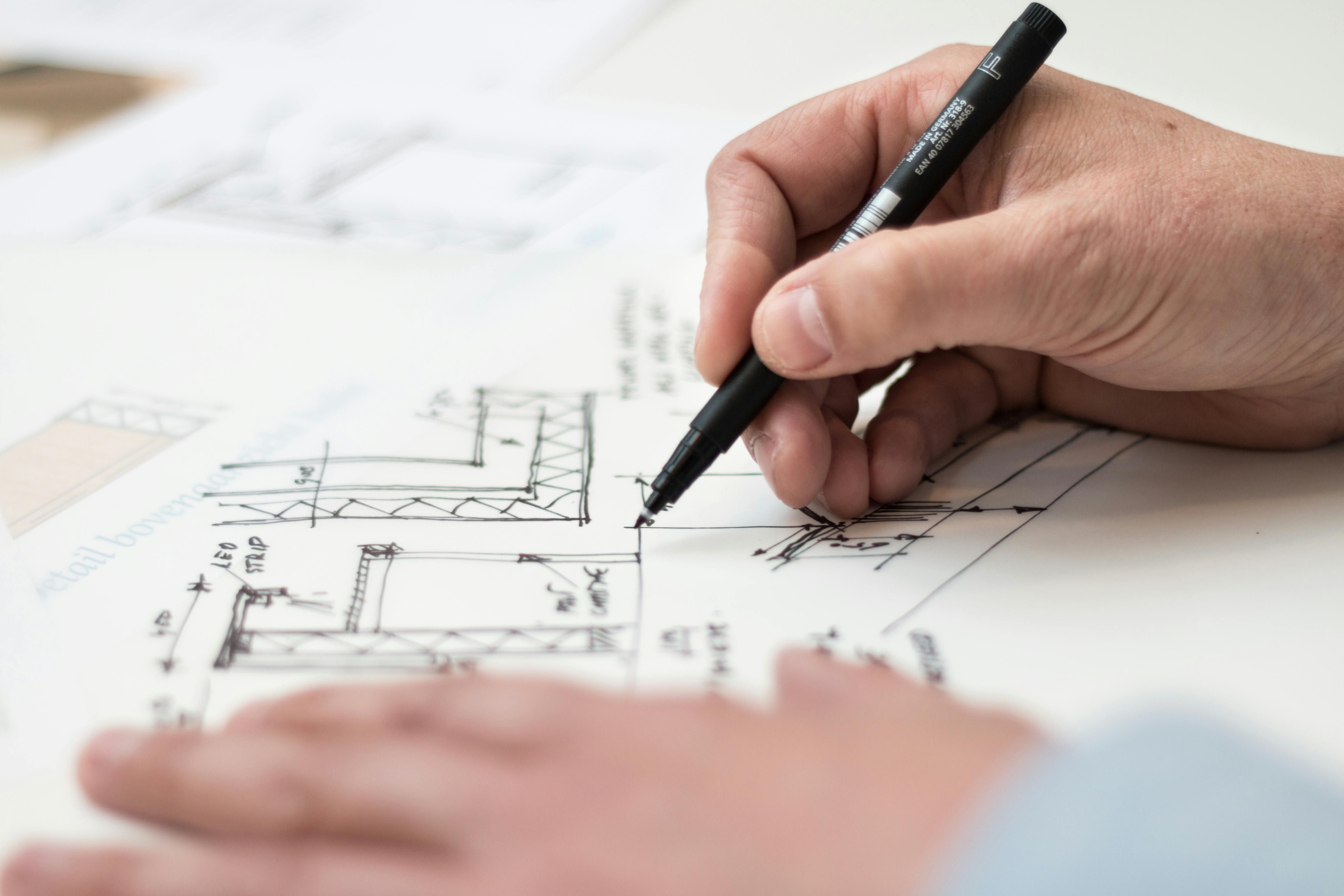 An individual working on architectural drawings