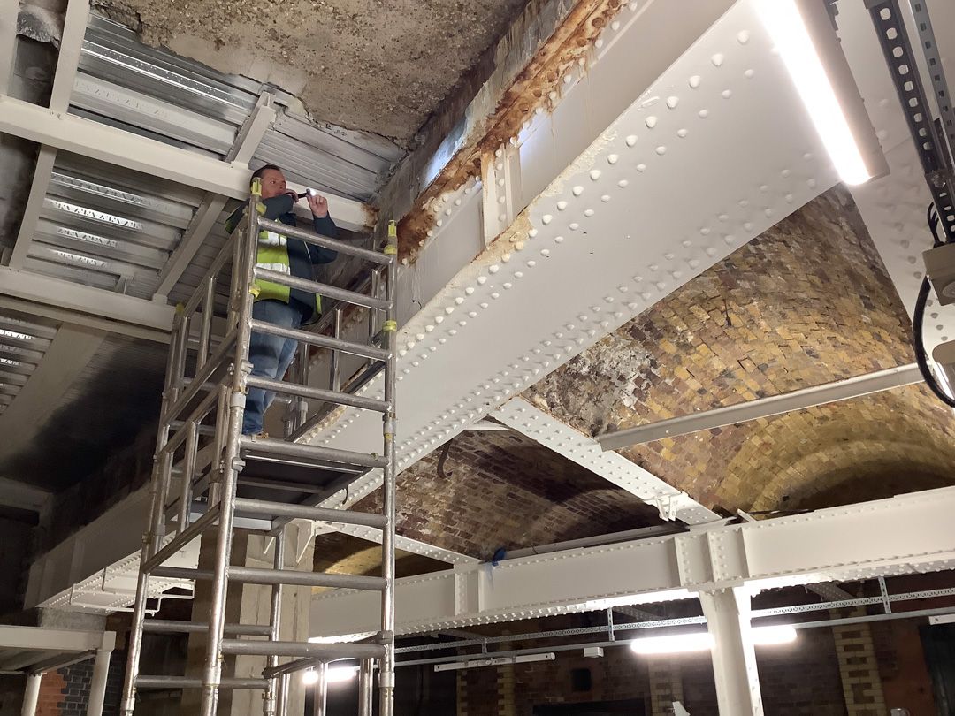 An individual conducting a structural survey