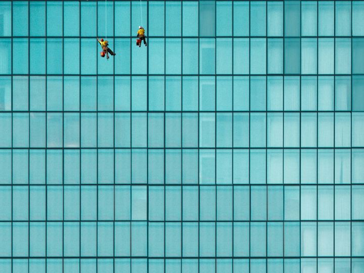 3 surveyors conducting reviews while rappelled from a building