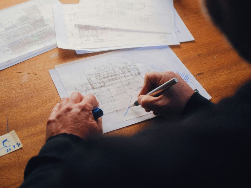 An individual working on architectural drawings