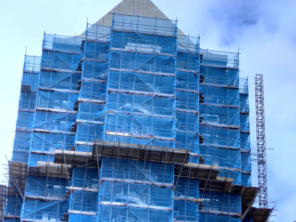 An old building covered in scaffolding due to repairs