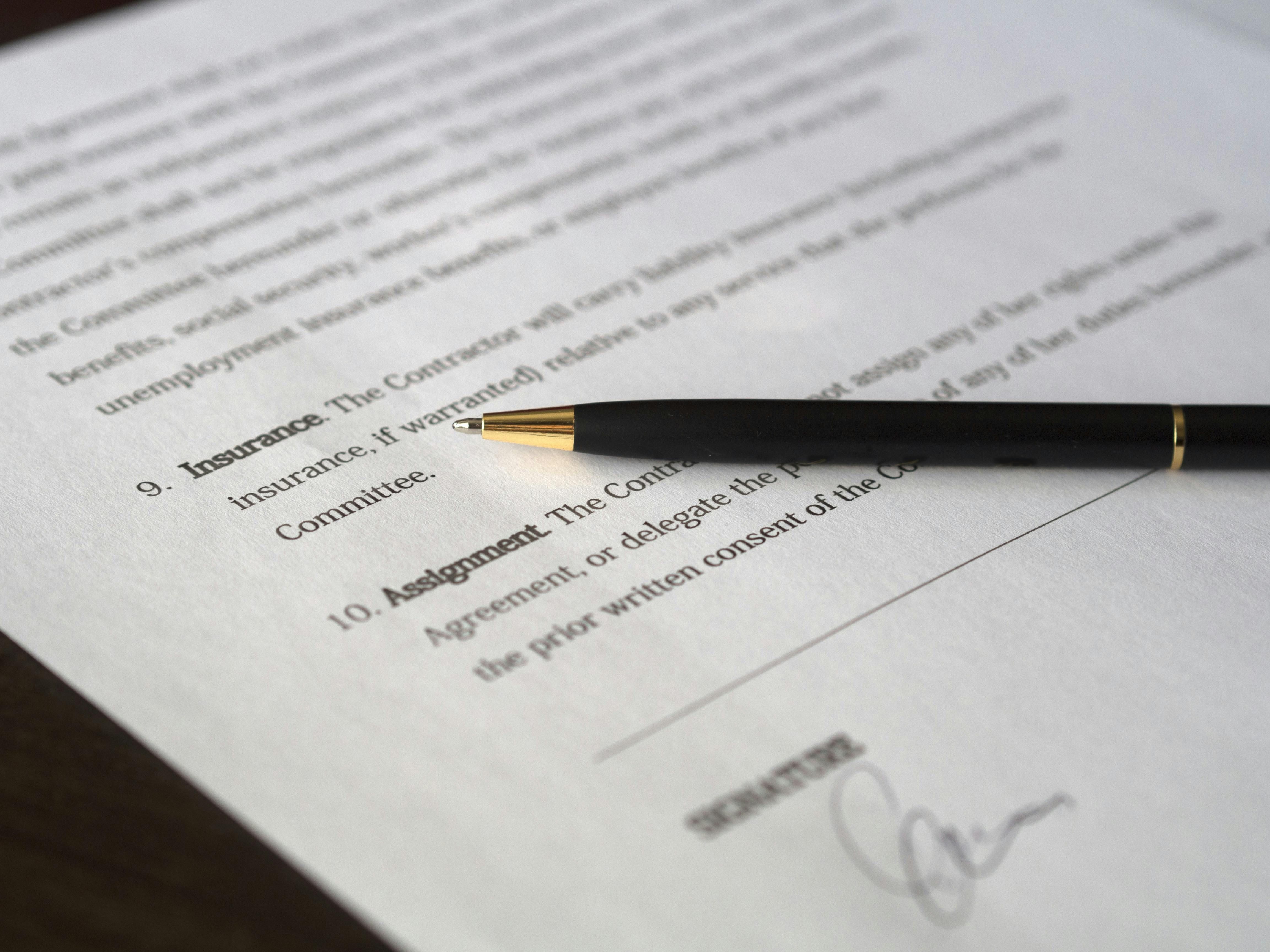 A pen resting on a contract